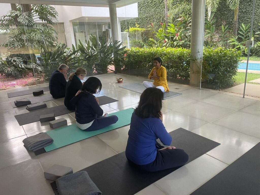 Yoga instructor guiding a group through meditation